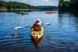 person kayaking on a calm river 