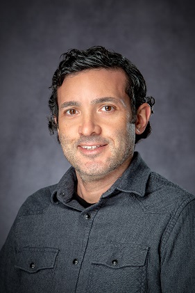 headshot of a man with dark hair 