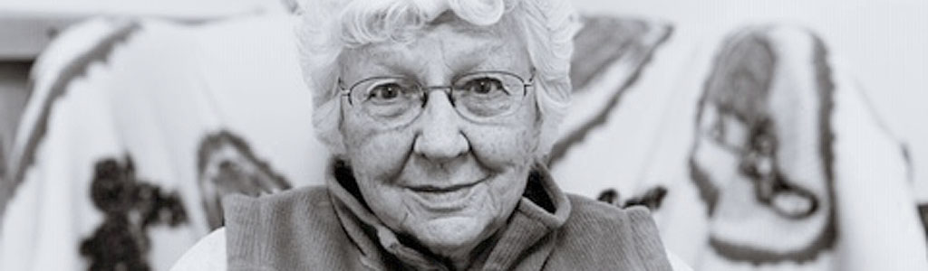 photo of elderly woman sitting in arm chair